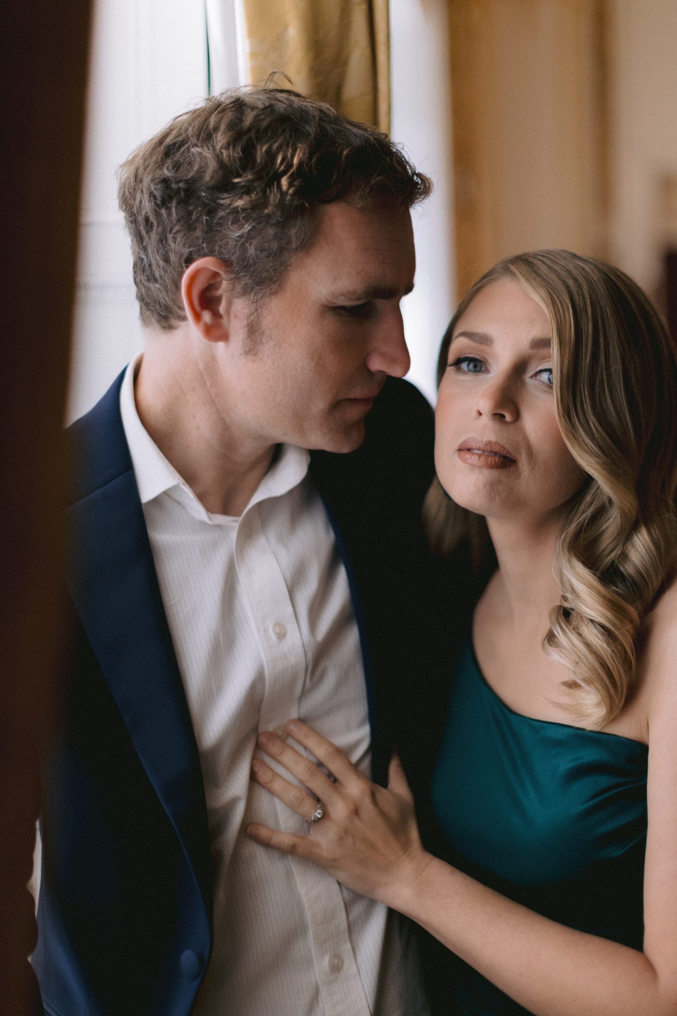 Romantic wedding couple portrait indoors with soft natural light and intimate moment