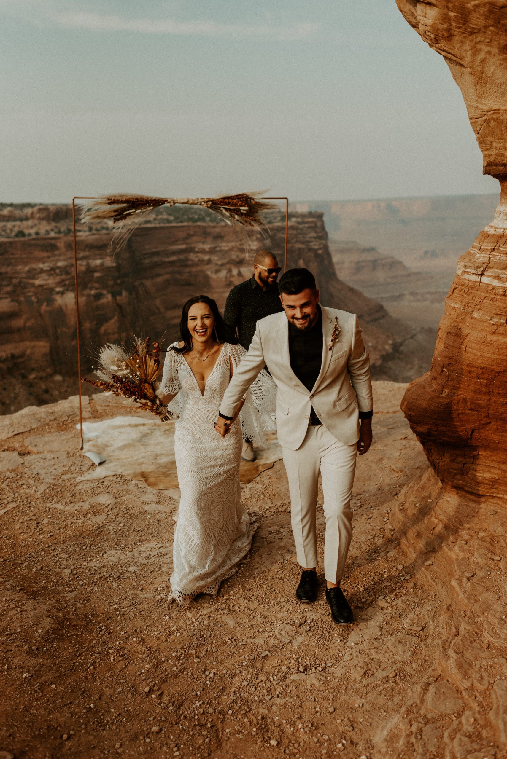 Adventure elopement wedding couple in canyon landscape with desert backdrop boho outdoor destination wedding photography