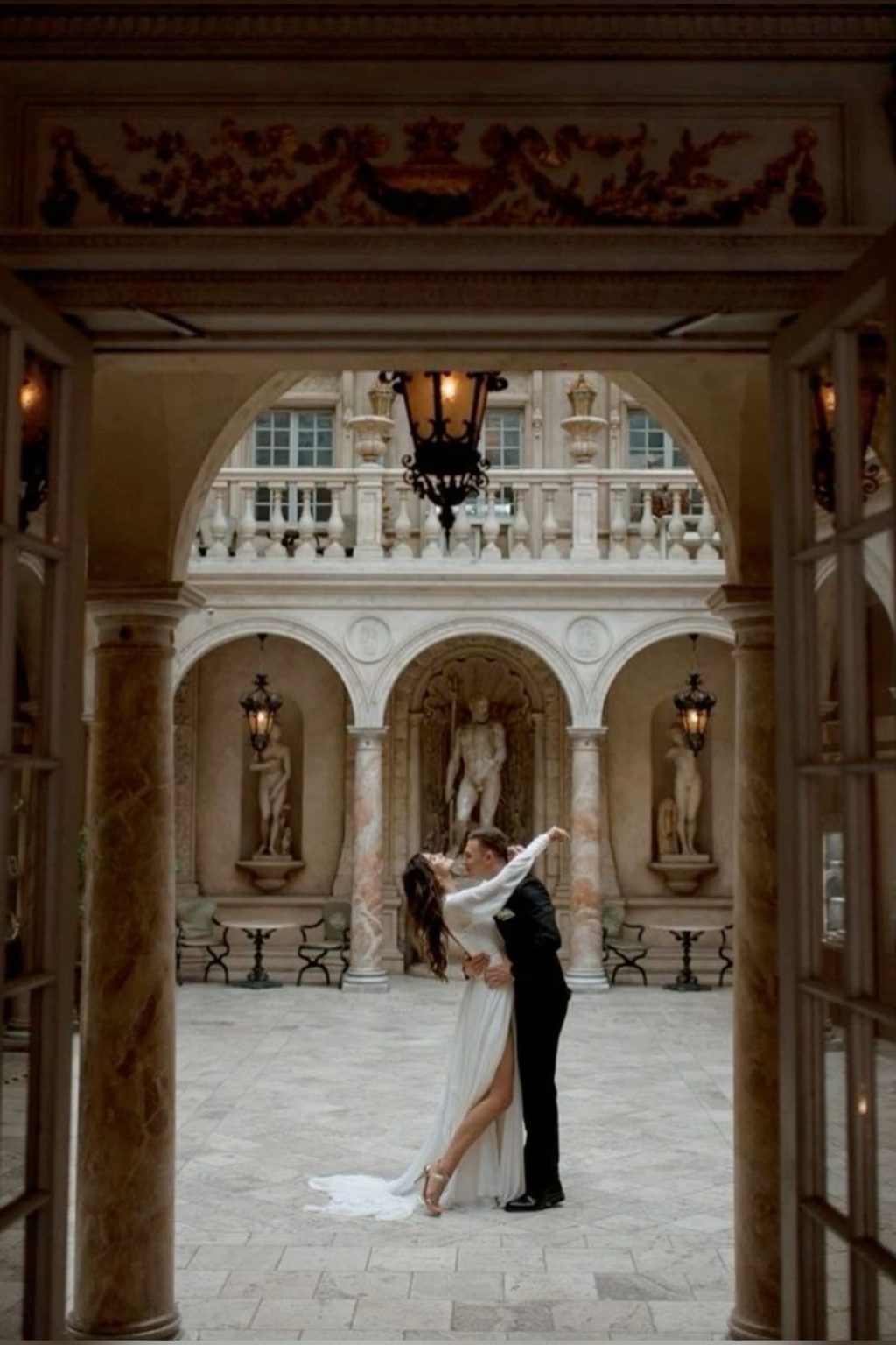 Luxury wedding couple portrait in elegant courtyard with classic architecture romantic fine art destination wedding photography