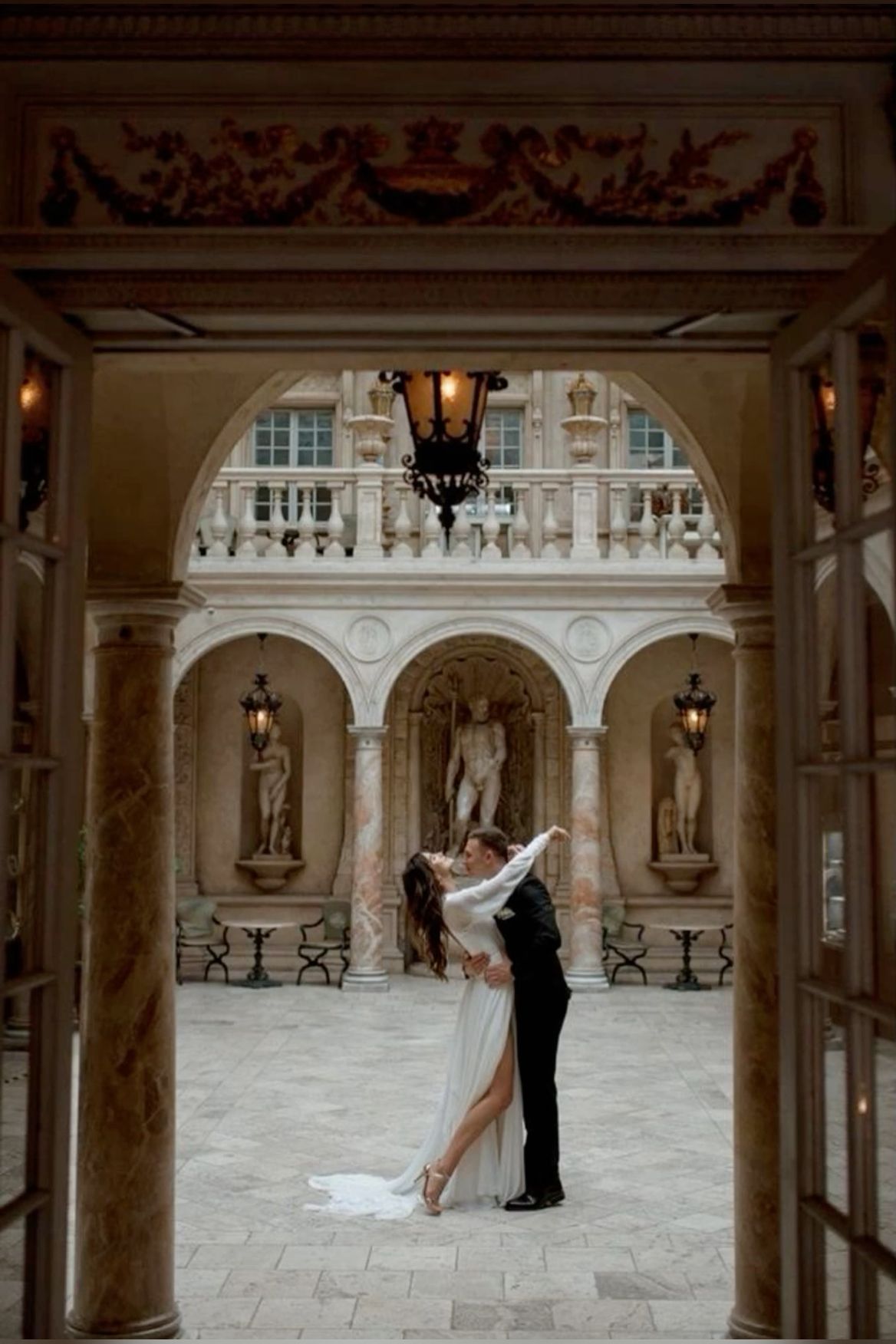 Luxury wedding couple portrait in elegant courtyard with classic architecture romantic fine art destination wedding photography