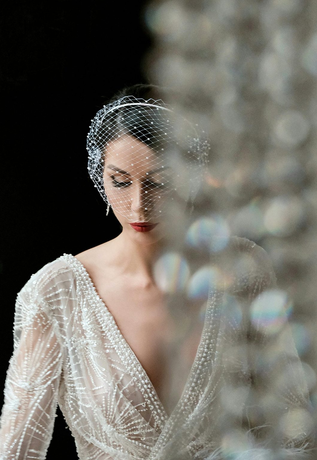 Luxury wedding videographer capturing editorial bridal portrait with veil and lace dress
