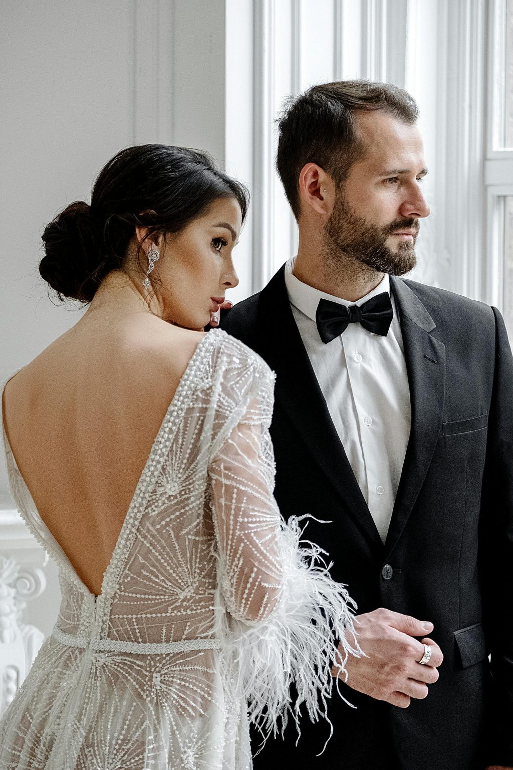 Luxury wedding videographer capturing elegant couple portrait with natural window light
