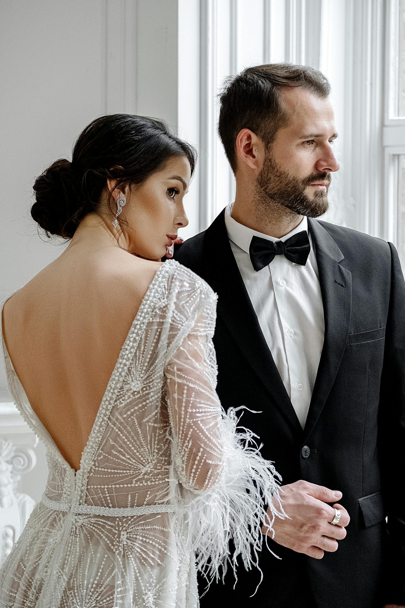 Luxury wedding videographer capturing elegant couple portrait with natural window light