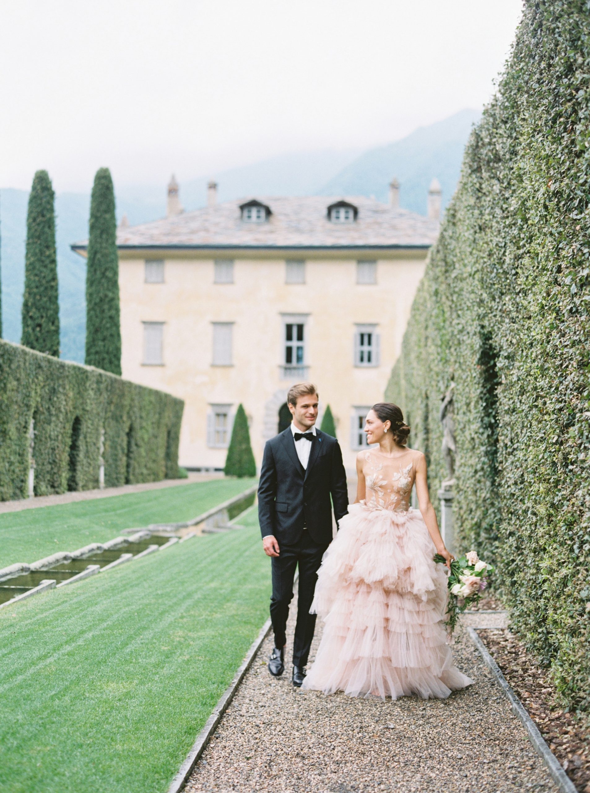 Cinematic luxury wedding couple at Villa Balbiano Lake Como Italy walking through garden