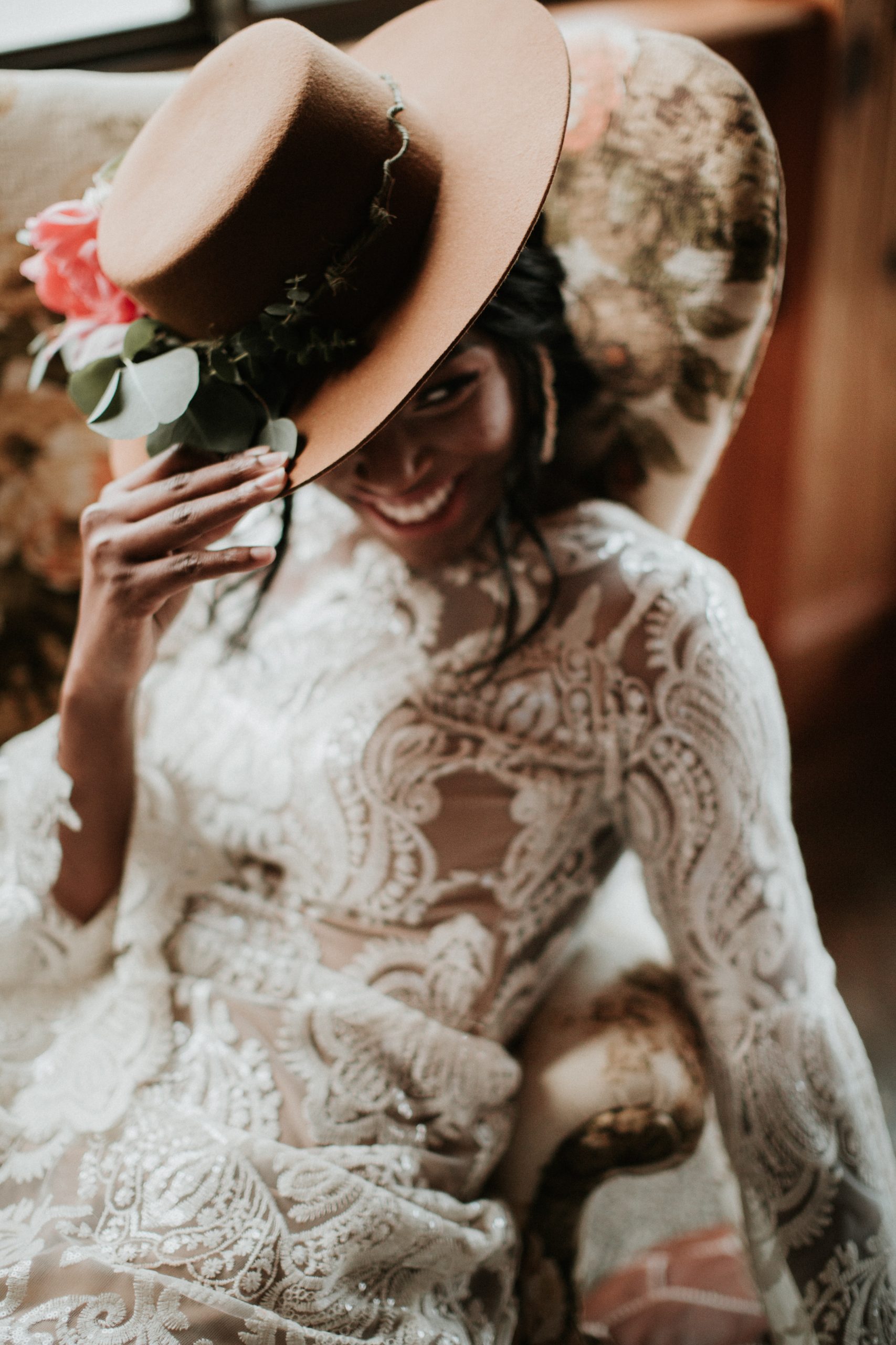 Luxury wedding videographer capturing bridal portrait with lace dress and hat